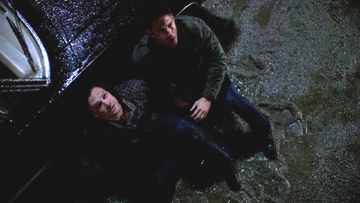 Dean gets Sam outside next to the Impala. Dean gets Sam outside next to the Impala.